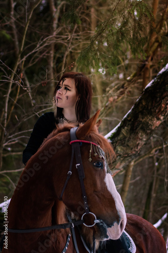 Fotomural a Viking girl riding a red horse painted in black runes