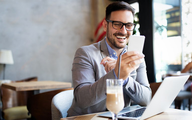 Wall Mural - Portrait of businessman working, talking on mobile phone in office