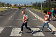© WavebreakMediaMicro - Two schoolgirls crossing the road on a pedestrian crossing