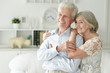 © aletia2011 - Portrait of cheerful senior couple embracing at home