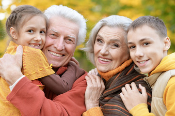 Canvas Print - Happy grandfather, grandmother and grandchildren in park