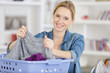 woman or housewife sorting laundry at home