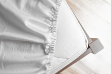 Bed Corner With White Fitted Sheet. White Sheet With Elastic Band. Flat Sheet Or Bed Cover.