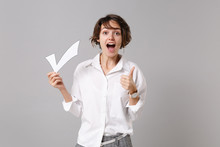 Excited Young Business Woman In White Shirt Posing Isolated On Grey Background Studio Portrait. Achievement Career Wealth Business Concept. Mock Up Copy Space. Hold Paper Check Mark, Showing Thumb Up.