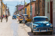 classic cars on a colorful street in trinidad, cuba