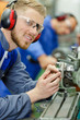 © auremar - portrait of engineer using machinery and wearing goggles