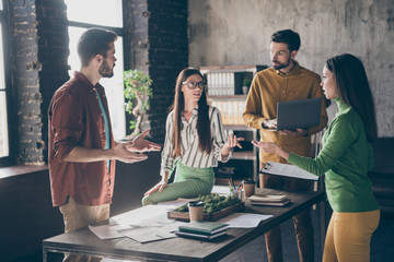 Poster - Company of four nice focused busy hardworking skilled qualified intelligent people professional IT specialists discussing profit growth at industrial loft interior style work place station office