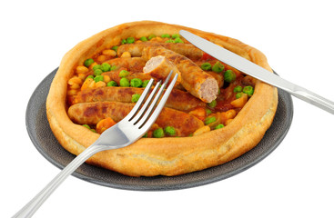 Wall Mural - Sausage and bean casserole served in a large Yorkshire pudding isolated on a white background