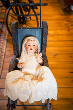 Antique Doll In A Carriage