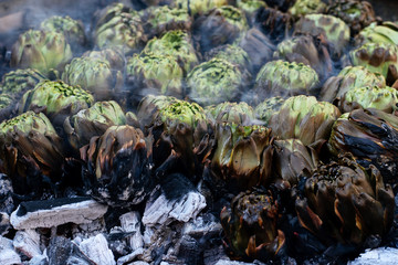 Wall Mural - Fresh exotic artichokes baking in brazier on the coal. Holiday, market place.