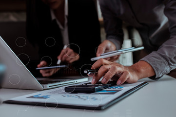 Stock exchange market concept, business teamwork looking on tablet and laptop with graphs analysis candle line in office.