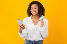 Black Woman Holding Credit Card And Mobile Phone
