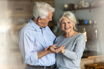 Poster - Senior couple dancing together in their home