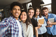 © Prostock-studio - International friendship concept. College friends taking selfie