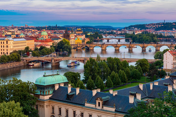 Prague, Czech Republic bridges panorama with historic Charles Bridge and Vltava river at night. Pargue at dusk, view of the Lesser Bridge Tower of Charles Bridge (Karluv Most). Czechia.