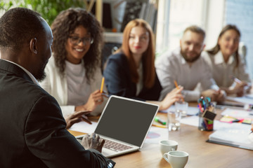 Wall Mural - Happy emotions. Group of young business professionals having a meeting. Diverse group of coworkers discuss new decisions, plans, results, strategy. Creativity, workplace, business, finance, teamwork.