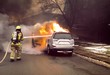 Firefighter extinguish a car fire with fire hose