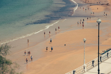 Walkers by the beach in San Sebastian