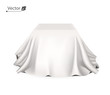 Box covered with white silk cloth. Empty podium, stand with tablecloth to show magic tricks. Secret gift, hidden under satin fabric with drapery and folds.