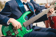 Bass guitarist with a green bass guitar at a concert