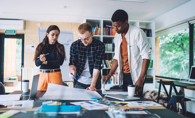 Sticker - Diverse architects discussing blueprint together