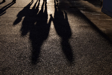 family shadow reflection on the ground at sunset