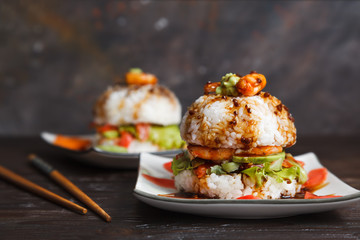 Homemade sushi vegan Burger with red fish, avocado, lettuce, pickled ginger, shrimp and teriyaki sauce