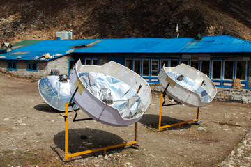 Warming the teapot in a solar cooker. Ecology concept. Renewable green energy. Nepal. Himalaya.