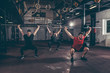 © Srdjan - Group of three young friends fit muscular fitness guys having fun by hard core cross workout training in the home made gym with barbells and squats selective focus with film grain