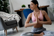 © Marharyta Hanhalo - Sportive healthy lifestyle people, copy space, young and beautiful woman doing yoga exercises at home interior, looking away and smiling. Happy people, relax and comfort. Strong woman body