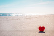 © dvoevnore - Romantic symbol of red heart on the sand beach