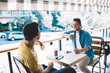 © BullRun - Excited male talking to friend in cafeteria