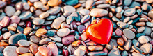 Romantic Symbol Of Red Heart On The Pebble Beach