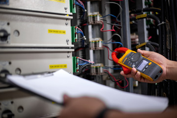 Electrical engineering uses a multimeter to measure the electrical current of wires.