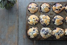 Blueberry Muffins In Old Pan On Rustic Farm Table, Natural Light, Vertical, Copy Space, Edge