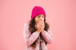 © be free - no flu this winter. wear warm clothes in cold season. winter holiday activity. little beauty pink wall. kid fashion style. child knitted hat and puffer coat. small girl catch cough. It is so cold