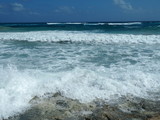 Fototapeta Niebo - Waves Crashing into Rocks on Coast of Cozumel, Mexico
