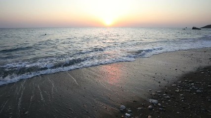 Wall Mural - waves roll on the seashore at sunset