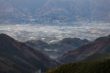 Looking Down At Kinokawa, A Small Japanese Town Nestled In Valley Between Mountains