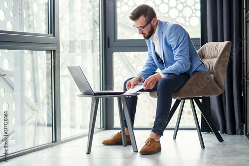 Cuadros en Lienzo business caucasian man sitting in working with laptop in office near window