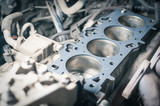 Fototapeta Na ścianę - Car engine repair. cylinder head gasket replacement in workshop