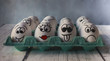 © Monic249 - White eggs with painted faces in the shell