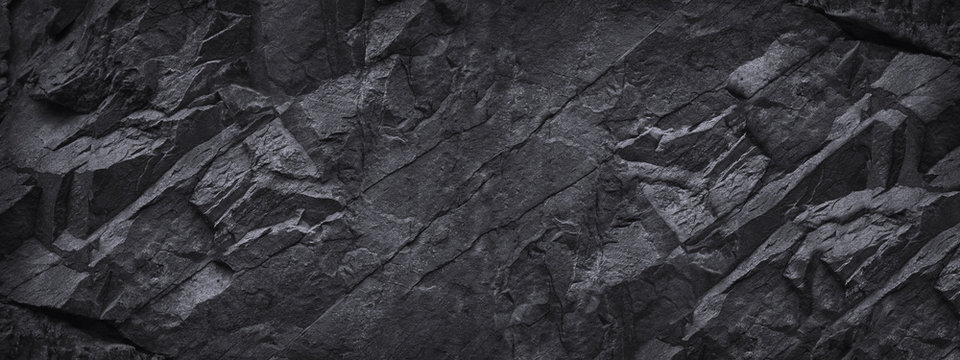 Wall Mural -  - Black white stone background. Dark gray grunge banner. Mountain texture. Close-up. Volumetric.  Rock background with space for design. Detail.  Wide banner. Long. Panoramic.