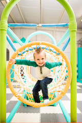 Happy Toddler Explores in jungle gym tunnel