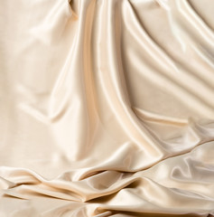 Abstract white wavy textile silk background with milky, creamy, champagne color
