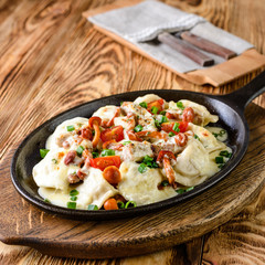 Wall Mural - homemade dumplings with forest mushrooms in a pan