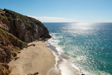 Beach Cliff View Of Beautiful Blue Pacific Ocean And Stunning Cliffs Surrounding Dume Cove On A Sunny Day With Clouds In The Sky, Point Dume, Malibu, California