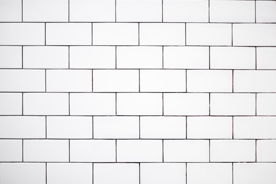 Wall Mural - white classic ceramic tiles on the wall in the bathroom, brick tiles, background