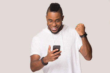 Wall Mural - Happy african American man hold smartphone get good message