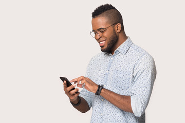 Happy black man using smartphone get pleasant message